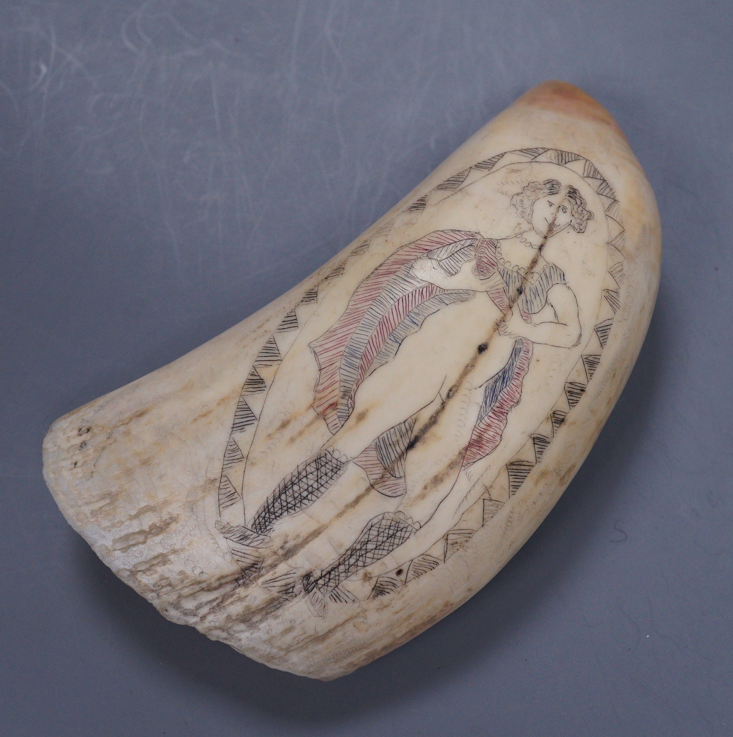 An erotic carved scrimshaw whale tooth, 13cm